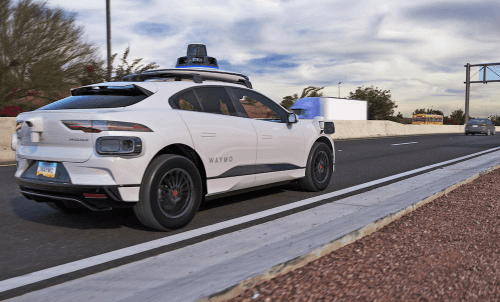 autonomous vehicle on a suburban road, equipped with rooftop sensors